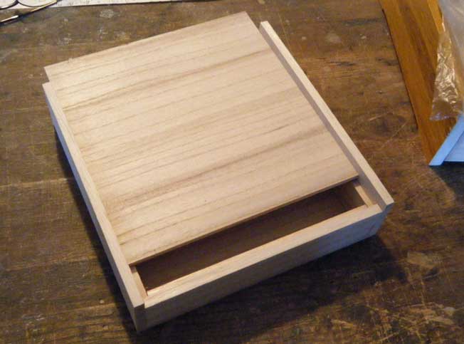 shallow wooden box with lid